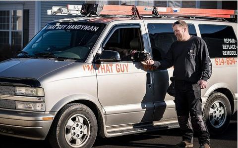 Matt Adamson standing beside the I'm That Guy Handyman Service van